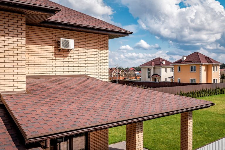 Brown roof shingle of new house in Lakeville, and blue cloudy sky