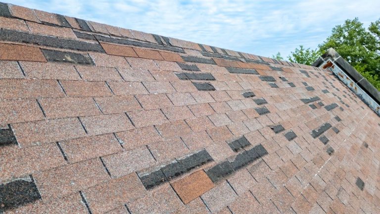Roof with missing shingles from storm damage, Lakeville MN