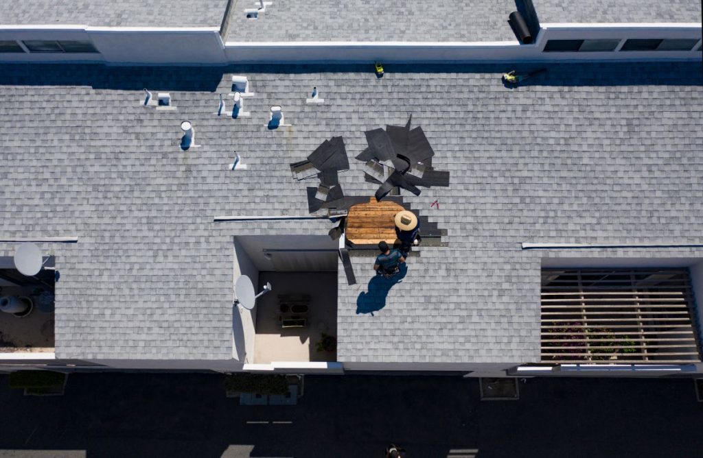 aerial view of roofers fixing a shingle roof in Lakeville