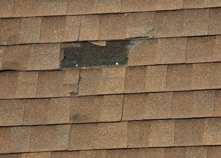 missing shingle on a brown shingle roof in Lakeville